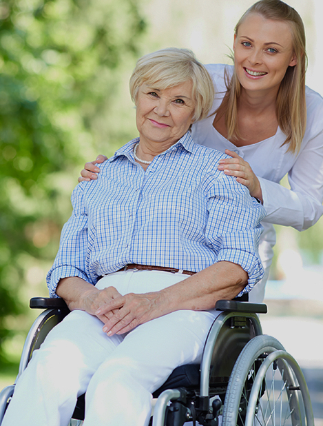 Bild  Frau Rollstuhl mit fürsorglicher zweiter Person